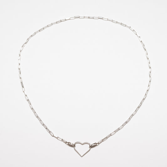 Silver necklace with a heart-shaped clasp on a light gray background